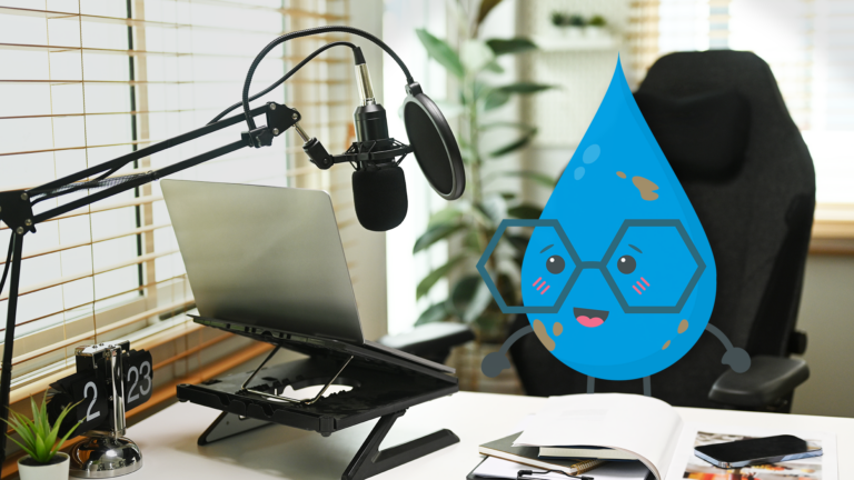 Walter, a water drop with cool glasses, sits in front of a laptop and a professional mic